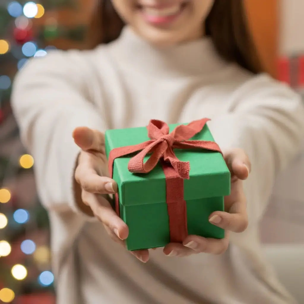 A woman holding a Christmas present.