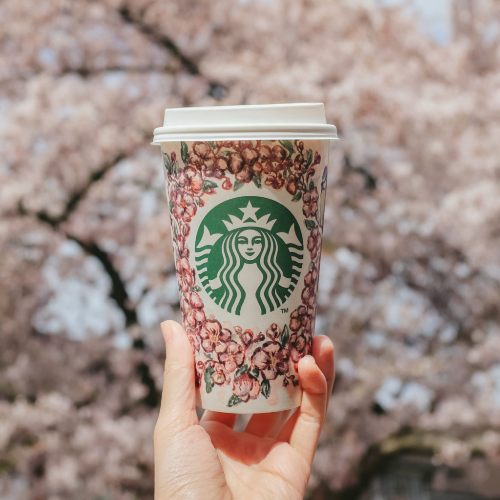 Someone holding a Starbucks Sakura cup.